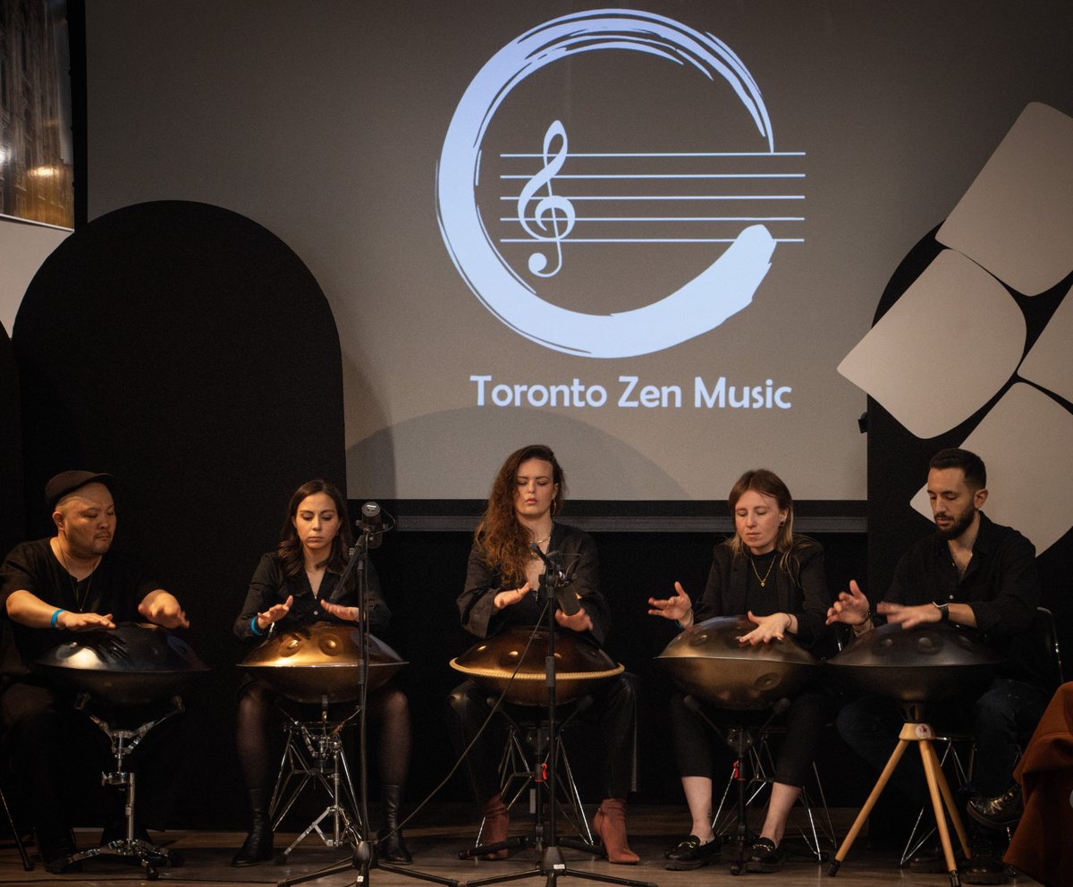 Five handpan musicians performing together